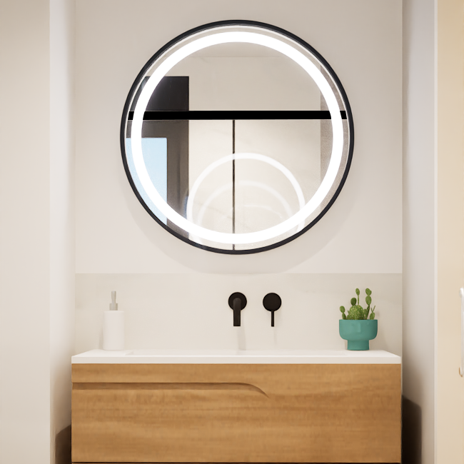 Cuarto de baño moderno con lavabo, espejo circular iluminado y planta en una repisa.